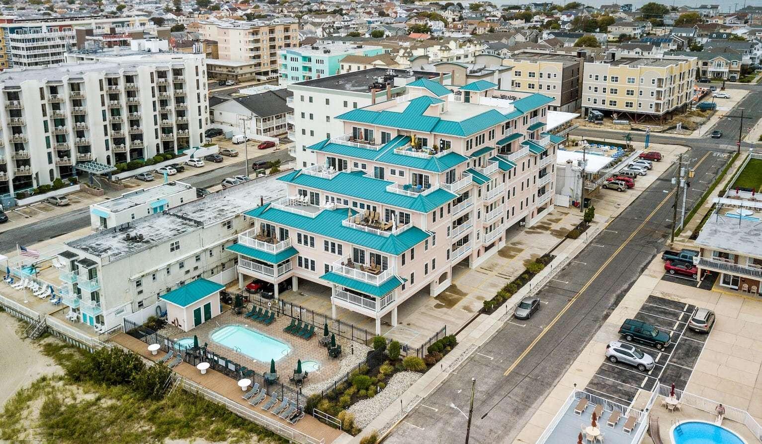 520 EAST STOCKTON ROAD  STOCKTON BEACH HOUSE #202 - WILDWOOD CREST BEACHFRONT SUMMER VACATION RENTALS with POOLS at WILDWOODRENTS.COM managed by ISLAND REALTY GROUP - Welcome to your dream vacation rental in Wildwood Crest! This stunning property can comfortably sleep up to 9 guests in its 3 bedrooms and 2.5 bathrooms. As you step inside, you'll be greeted by a beautifully furnished living space featuring 2 Queen Beds, 2 Single Beds, and a cozy Queen Sofa Bed, ensuring everyone has a comfortable place to rest after a day of beach fun. The property is equipped with modern amenities such as a dishwasher, microwave, coffee maker, and toaster, making meal preparation a breeze. Enjoy the convenience of central AC, ceiling fans, and gas heat to keep you comfortable year-round. Entertainment options abound with 4 TVs, cable TV, and high-speed internet. The outdoor pool is heated, perfect for a refreshing dip, and there's even a community hot tub for ultimate relaxation. Step outside to the deck and take in the fresh sea breeze while grilling up a feast on the gas BBQ. The rooftop deck offers panoramic views of the area, ideal for sunset cocktails. This property is pet-free and smoke-free, ensuring a clean and comfortable environment for all guests. Beach equipment, including chairs and umbrellas, is provided for your convenience. With 2 parking spaces, washer and dryer, and additional amenities like beach chairs, a crockpot, and Keurig coffee maker, this rental has everything you need for a memorable stay. Don't miss out on this fantastic opportunity to experience Wildwood Crest in style. Book now and start counting down the days to your beachside getaway! Wildwood Crest Rentals, North Wildwood Rentals, Wildwood Rentals and Diamond Beach Rentals in all price ranges for weekly, monthly, seasonal and weekend vacation rentals plus Wildwood real estate sales of homes, condos, vacation and investment properties in and around Wildwood New Jersey. We offer over 400 properties plus exclusive vacation homes so you can book the shore rental of your choice online and guarantee your vacation at the Shore. Rent with confidence at Island Realty Group! Visit www.wildwoodrents.com to book online or call our office at 609.522.4999. Our office at 1701 New Jersey Avenue in North Wildwood is open 7 days a week!